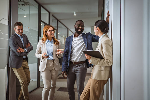 istock multicultural colleagues have informal meeting at company hallway 2218504998