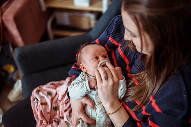 istock Mom rocking sleepy baby to sleep while at postpartum support group 2218505678