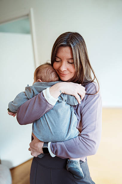 istock Mother lovingly embracing her baby 2218505702