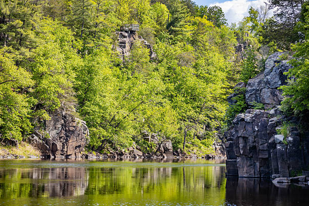 From the bluffs of Taylors Falls, visitors can enjoy panoramic views of the Dalles of the St. Croix River, featuring dramatic rock formations