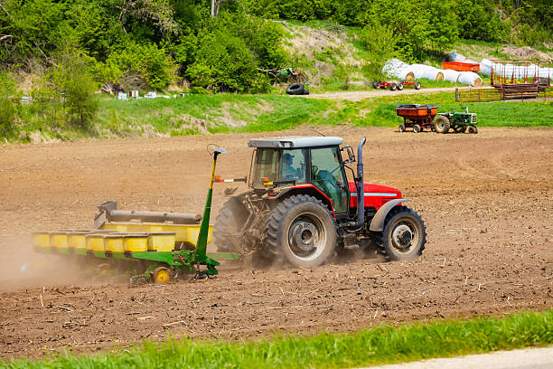 Sondheimer, LA - June 7, 2025: Corn field with farm implement in foreground, selective focus