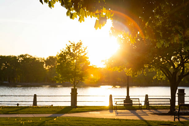 A scenic view of La Crosse's Riverside Park with the Mississippi River at sunset, offering a breathtaking landscape with vibrant sky colors reflecting on the water.