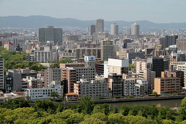 The Osaka skyline showcases a dynamic blend of modern skyscrapers, commercial towers, and urban sprawl, reflecting the city’s role as a vibrant economic and cultural hub in Japan. From high-rise buildings to distant mountains, this cityscape captures the scale and energy of one of Japan’s largest metropolitan areas.