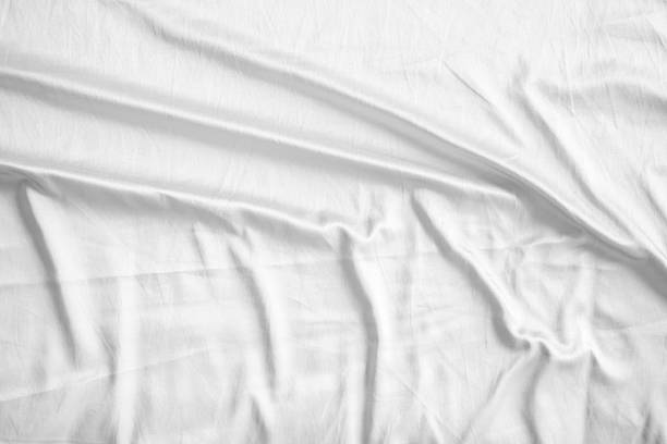 istock Abstract white wrinkled bedding sheet fabric texture background 2218509318