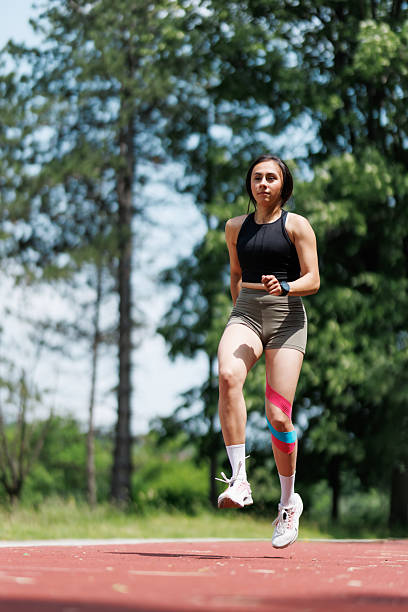 istock Young Woman Jumping on a Track Outdoors on a Summer Day 2218509506