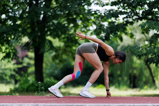 istock Athletic Woman Stretching on Track Outdoors Surrounded by Greenery 2218509572