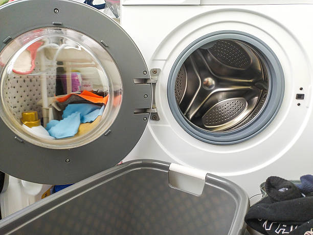 istock Open washing machine filled with clothes, ready for a fresh start. Symbolizes routine, cleanliness, and domestic tasks. Perfect for lifestyle  home organization themes. 2218510057
