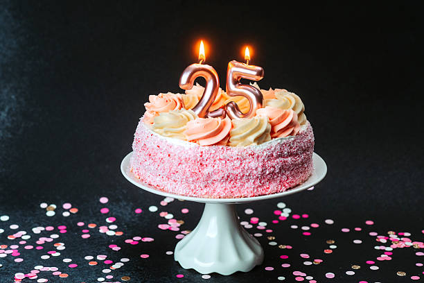istock Celebrating a 25th birthday with a beautifully decorated cake and candles 2218510577