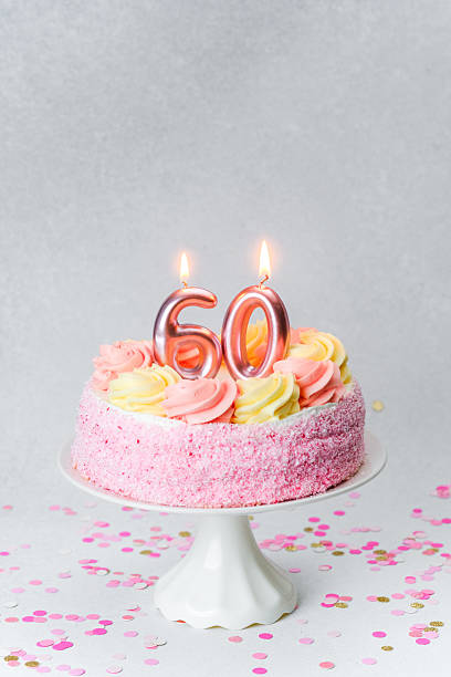 istock Celebrating a milestone birthday with a beautiful 60th cake adorned with candles 2218510582