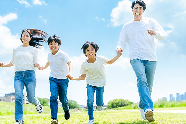istock A family running on a meadow with blue sky 2218514189