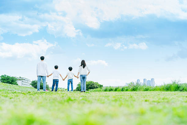 istock A family walking on a meadow against the blue sky 2218514210