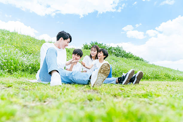 family playing under the blue sky