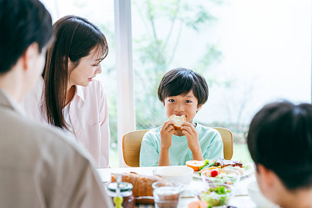 istock family eating at the dining room 2218514373
