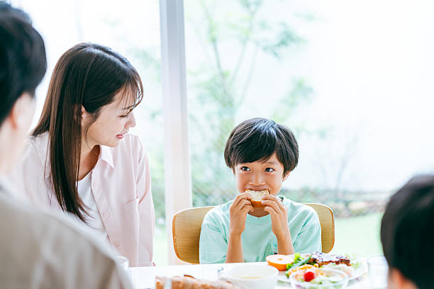 istock family eating at the dining room 2218514377