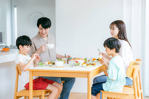 istock family eating at the dining room 2218514418