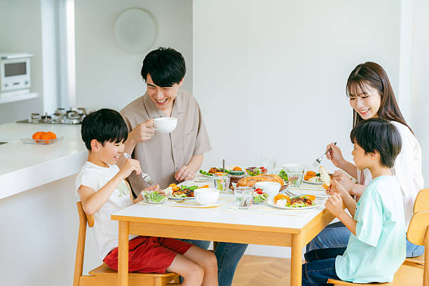 istock family eating at the dining room 2218514487