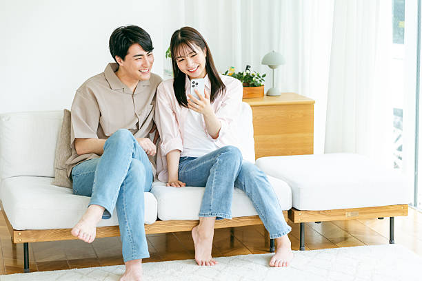 istock Cup looking at smartphone in living room 2218514610