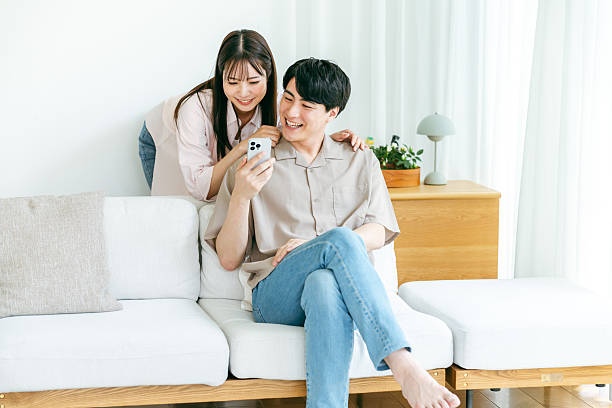 istock Cup looking at smartphone in living room 2218514669
