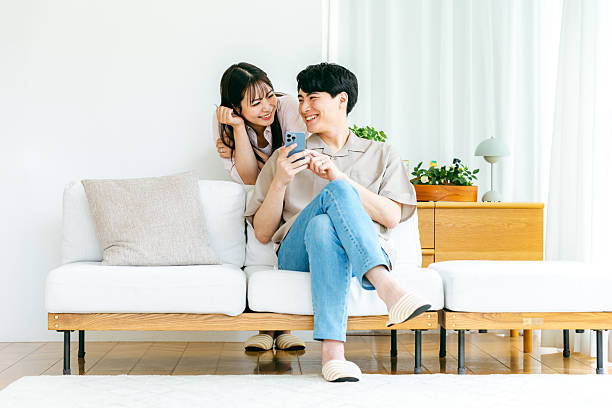 istock Couple looking at smartphone in living room 2218514862