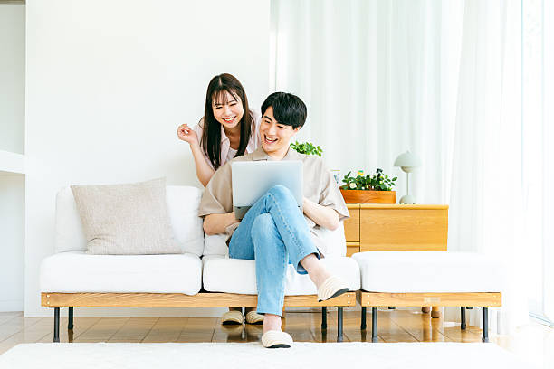 istock Couple looking at computer in living room 2218514873