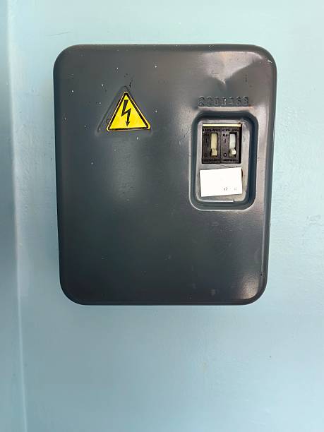 istock electrical meter mounted on wall with warning sign in utility area building. close up. 2218516332