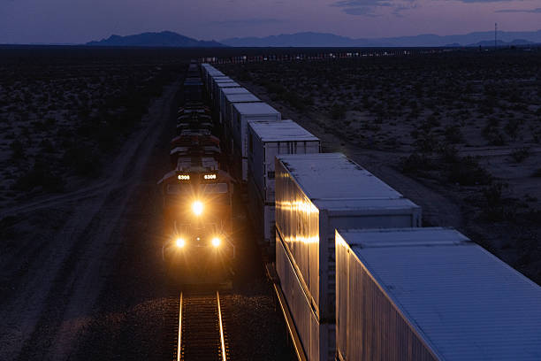 istock Two trains meet at dusk in desert environment 2218518154