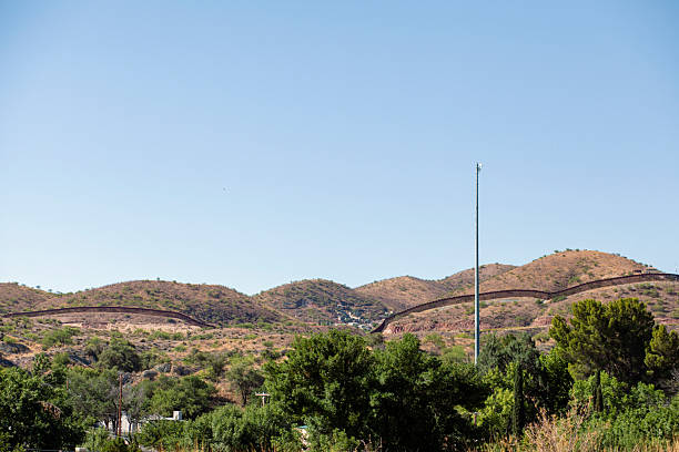istock Landscape and U.S. Mexico border wall in distance 2218518451
