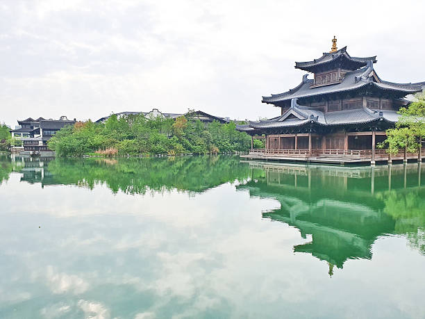 istock A serene temple complex with a pagoda reflects on a calm green lake, surrounded by lush trees and traditional architecture 2218518612