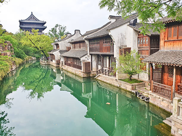 istock A serene temple complex with a pagoda reflects on a calm green lake, surrounded by lush trees and traditional architecture 2218518636