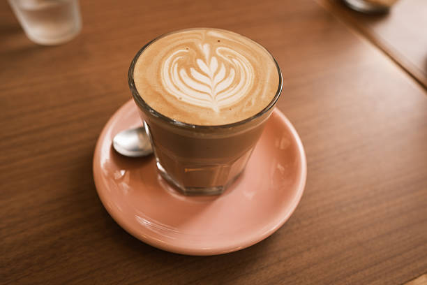 istock Latte in a glass on a pink saucer 2218518798