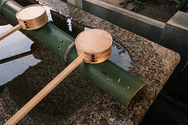 Close-up on two wooden ladles for drinking water.