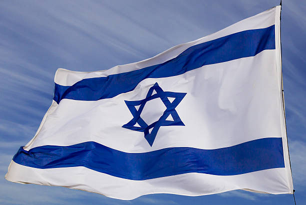 istock Israel flag flapping in the wind isolated against the sky 2218520380