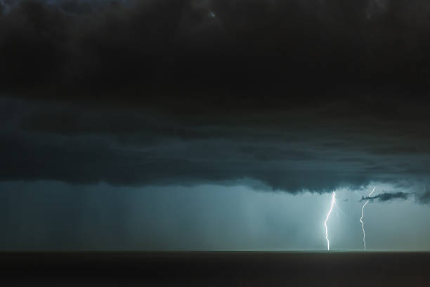 istock lightning bolts over the sea 2218520434
