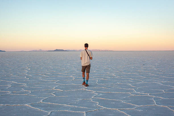 istock Photographer explores great salt flat at sunset 2218521419