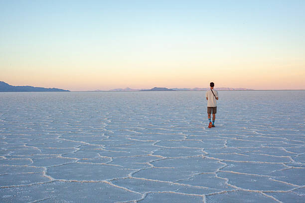 istock Photographer explores great salt flat at sunset 2218521424