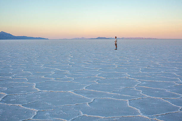 istock Photographer explores great salt flat at sunset 2218521461