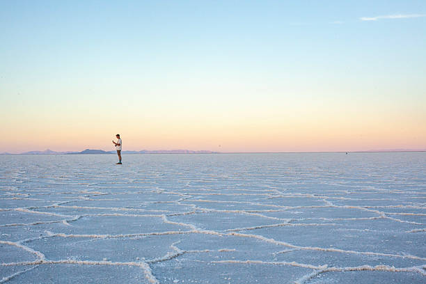 istock Photographer explores great salt flat at sunset 2218521463