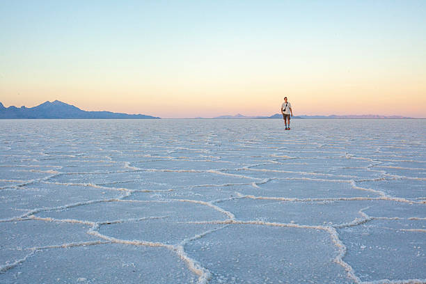 istock Photographer explores great salt flat at sunset 2218521477