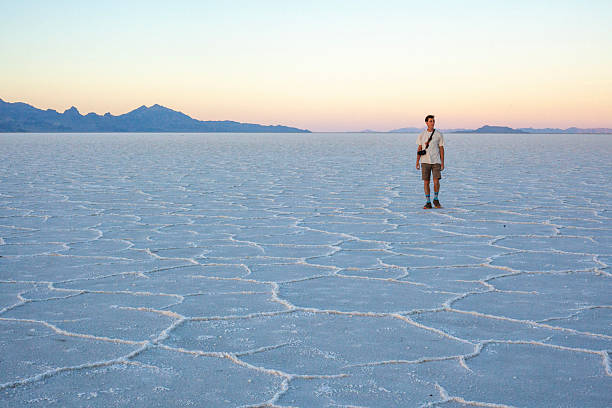 istock Photographer explores great salt flat at sunset 2218521489