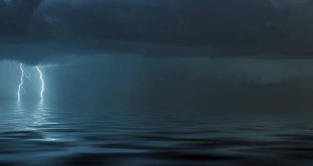 istock lightning bolts reflection over the ocean 2218522243