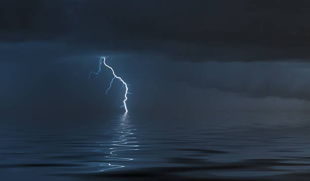 istock lightning bolts reflection over the sea 2218523234