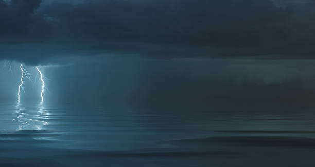 istock lightning bolts reflection over the ocean 2218524923