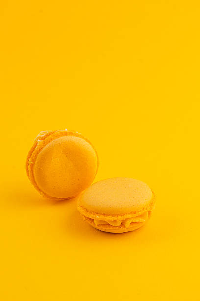istock Yellow macarons on a bright yellow background in dessert setting 2218528084