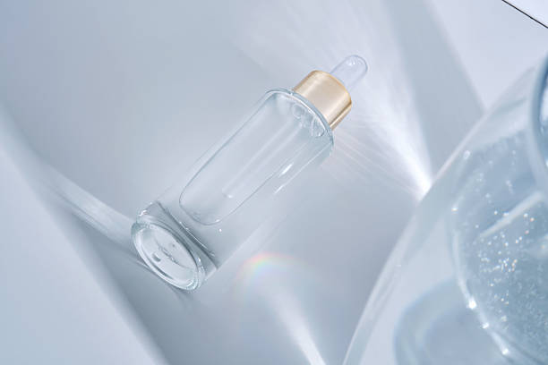 istock Bottle with serum on a white background with glare from water. 2218528477