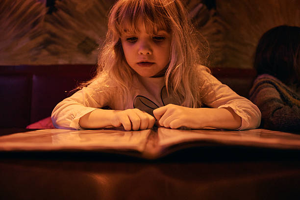Young girl outdoors with school books