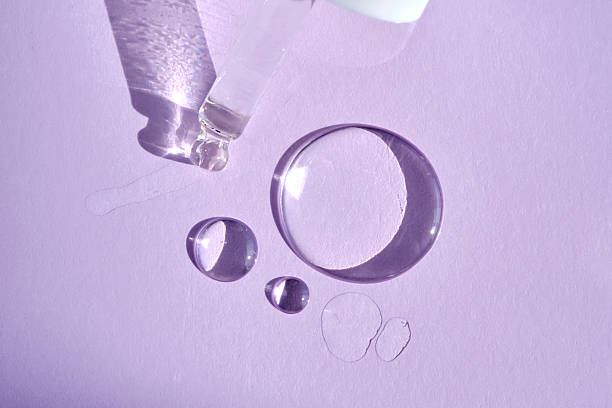 istock A drop of serum with a pipette on a purple background. 2218528781