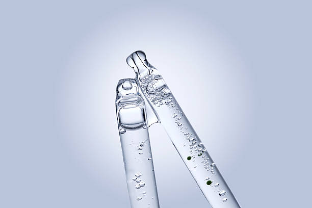 istock Two different face serum pipettes on a neutral background. 2218528901