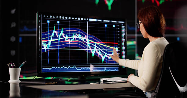 istock Young Female Financial Analyst Studies Market Trends On Computer 2218529063