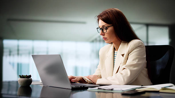 istock Female CEO Boosts Productivity With Laptop 2218529120