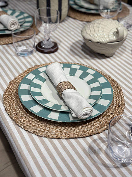 istock Image of formal dining table with crockery, cutlery, tablecloth, napkins, placemats, dinner plates / refined table setting 2218536448